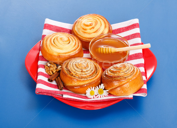 Stock photo: Cinnamon rolls and honey