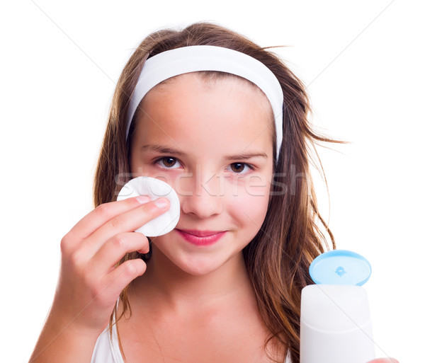 Girl cleaning her face with tonic lotion Stock photo © icefront