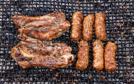 Fried meat slices on barbecue grid Stock photo © icefront