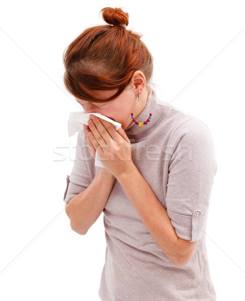 Stock photo: Young woman blowing her nose