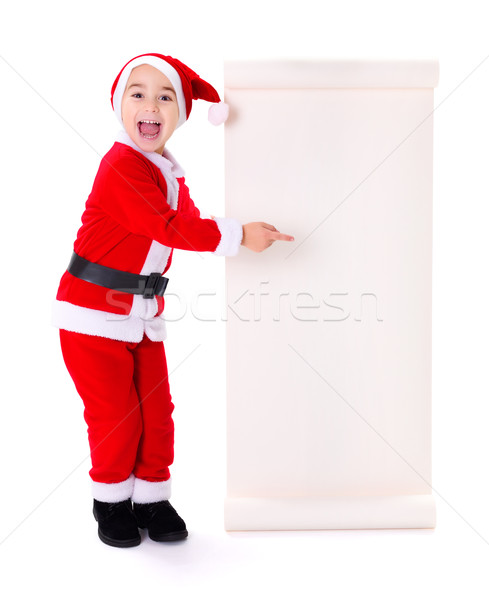 Little Santa Claus boy pointing at big wish list Stock photo © icefront
