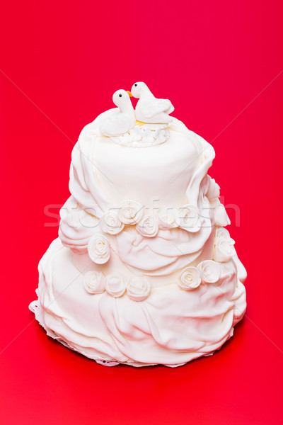 Stock photo: White wedding cake with bird topper