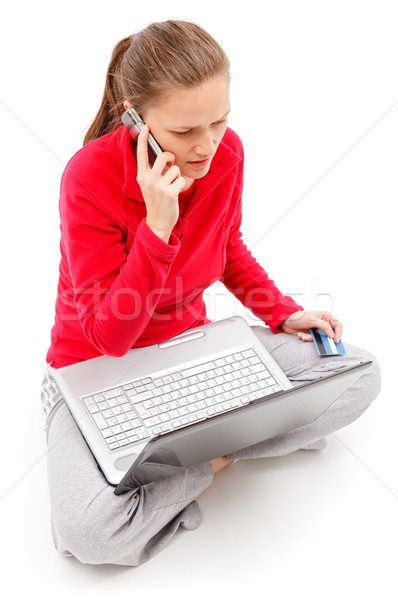 Girl talking on the phone with laptop in her lap Stock photo © icefront