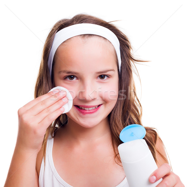 Girl cleaning her face with tonic lotion Stock photo © icefront