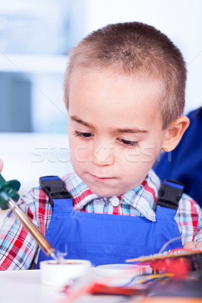 Child playing with soldering iron and resin Stock photo © icefront