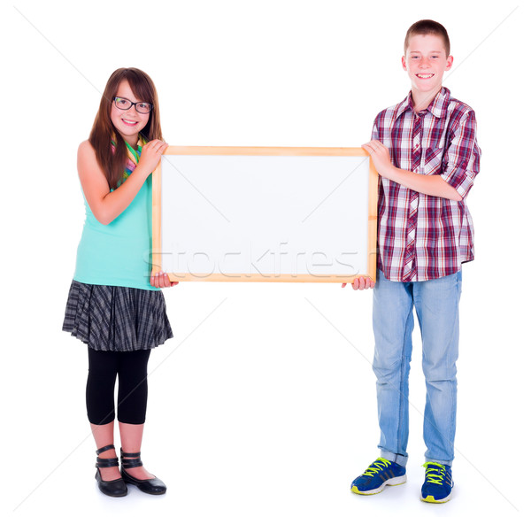 Boy and girl holding an empty advertising board Stock photo © icefront