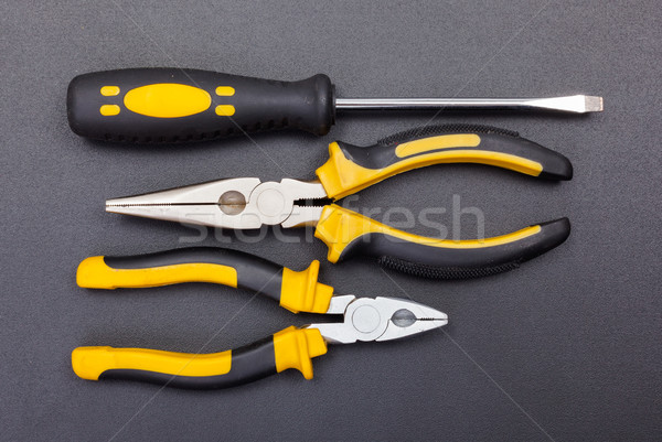 Stock photo: Pliers and screwdriver on black