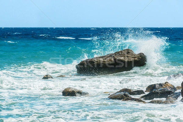 Moderate sea waves hitting the rocks Stock photo © icefront