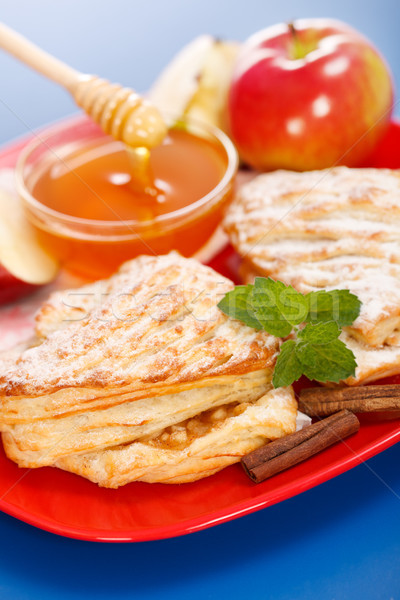 Stock photo: Apple cakes on plate, honey and apple pieces around