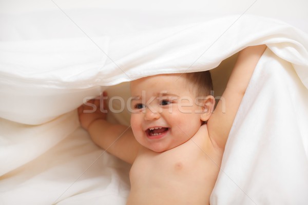 Happy baby uncovering Stock photo © icefront