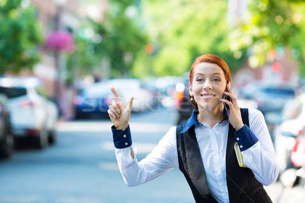 Young business woman talking on smart phone, hails taxi cab Stock photo © ichiosea