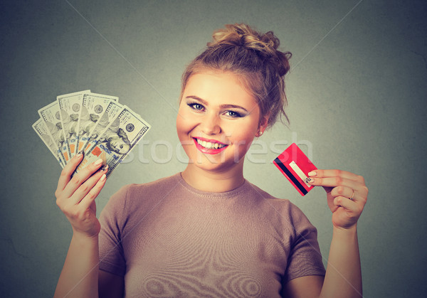 woman shopping holding showing credit card and cash dollar banknotes bills Stock photo © ichiosea