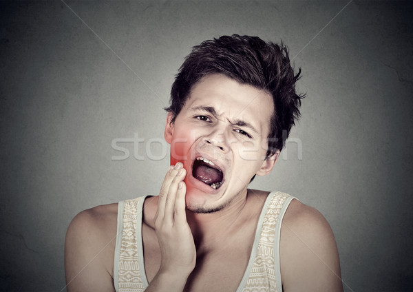 man with toothache tooth pain outside mouth cheek colored in red  Stock photo © ichiosea