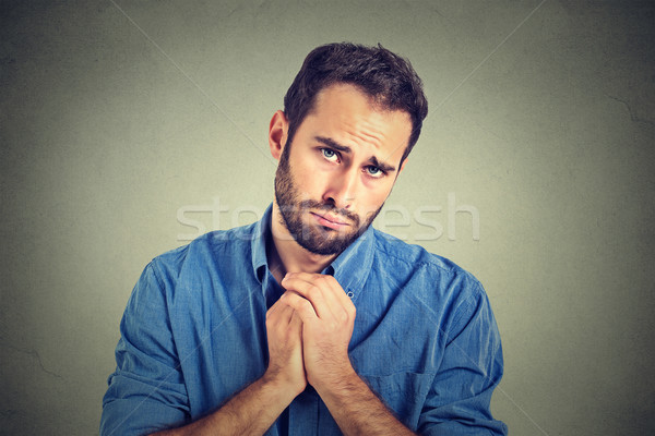 desperate young man showing clasped hands, pretty please asking help forgiveness  Stock photo © ichiosea