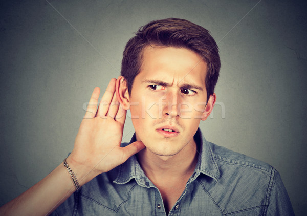 hard of hearing man placing hand on ear listening to gossip  Stock photo © ichiosea