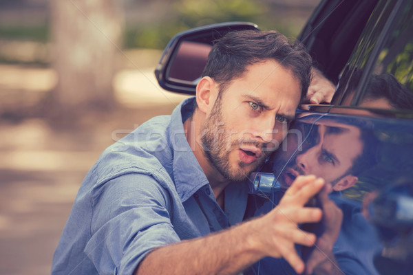 Worried funny looking man obsessing about cleanliness of his new car Stock photo © ichiosea