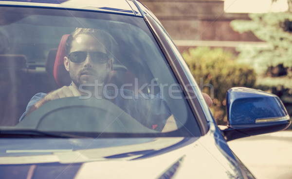 Handsome serious man driving a car Stock photo © ichiosea
