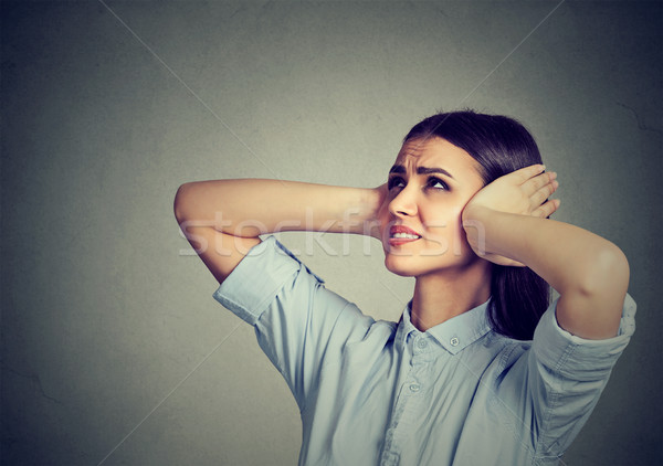 Stressed frustrated woman covering her ears with hands.  Stock photo © ichiosea