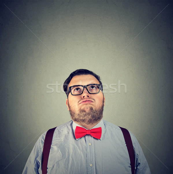 Stock photo: Tired annoyed man posing on gray