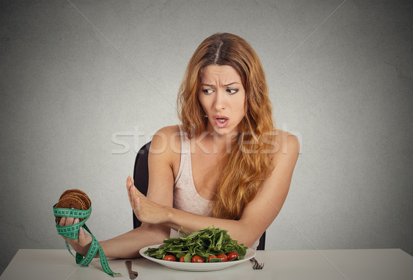 woman deciding whether to eat healthy food or sweet cookies she craving Stock photo © ichiosea