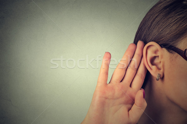 Woman holds her hand near ear and listens carefully  Stock photo © ichiosea