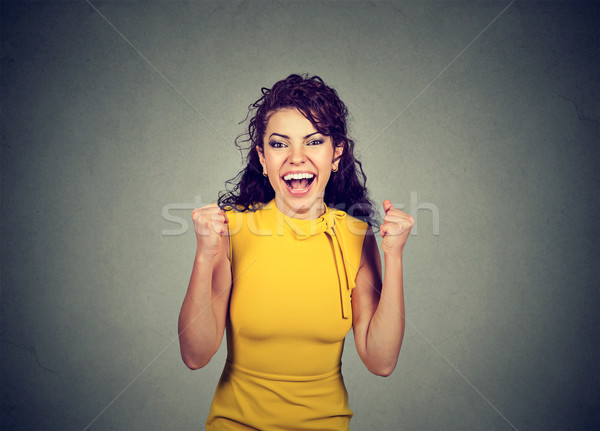 Successful woman with fists pumped celebrating success  Stock photo © ichiosea