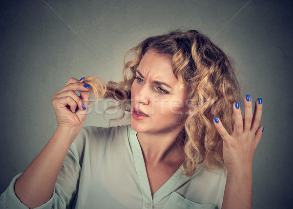 unhappy frustrated woman surprised she is losing hair receding hairline Stock photo © ichiosea