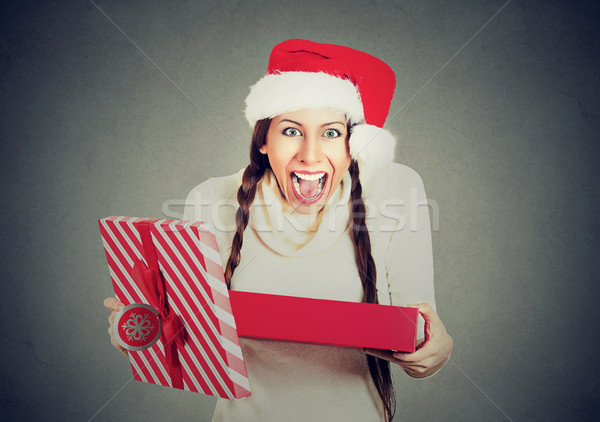 Stock photo: excited woman wearing red santa claus hat opening gift box 