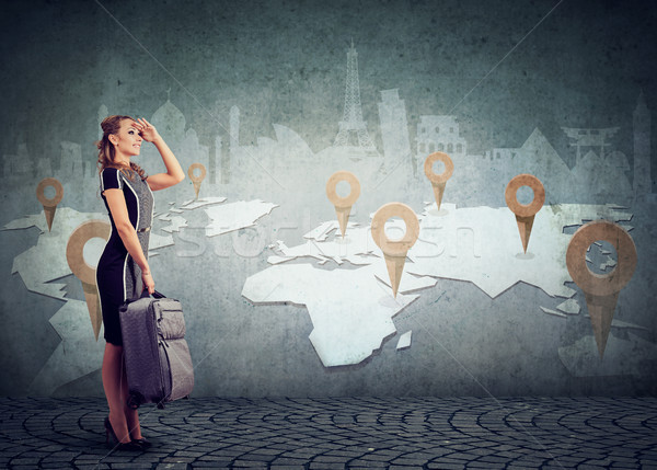 Woman with suitcase ready to explore the world on landmarks map background Stock photo © ichiosea
