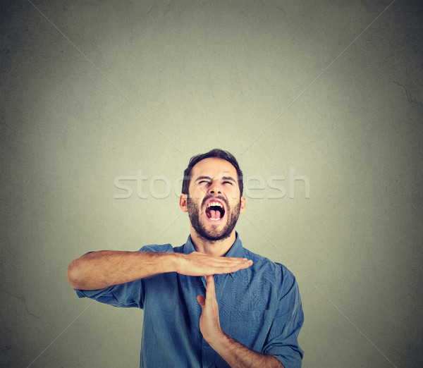 Stock photo: Young man showing time out hand gesture, frustrated screaming to stop