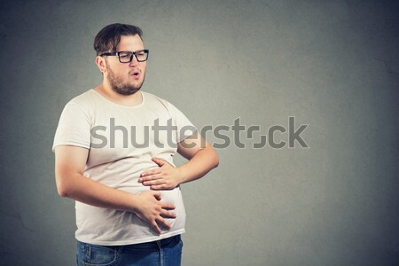 Stock photo: Young man with stomach pain indigestion