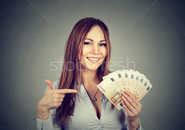 Successful young business woman holding money euro bills in hand  Stock photo © ichiosea