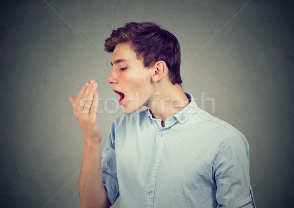 Mann Atem Hand junger Mann Essen Gesicht Stock foto © ichiosea
