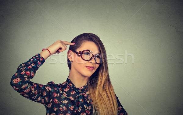 woman scratching head, thinking deeply about something, looking up Stock photo © ichiosea