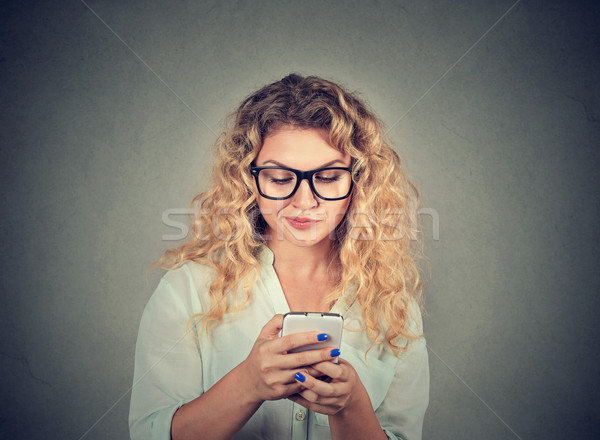 upset woman texting on mobile phone displeased with conversation Stock photo © ichiosea