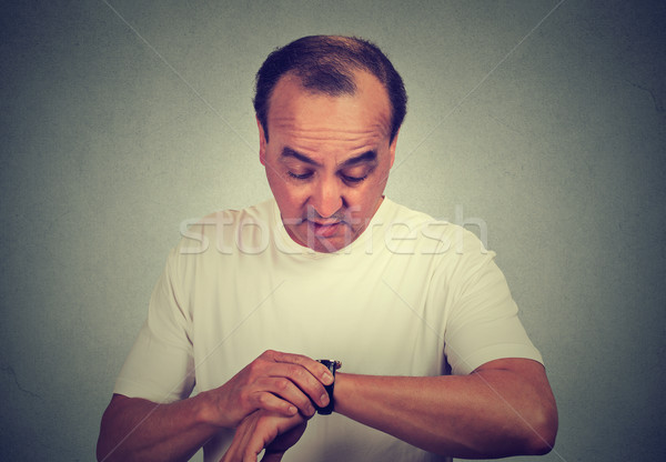 Surprised middle aged man looking at his wristwatch  Stock photo © ichiosea