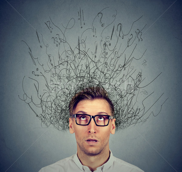 man with worried face expression brain melting into lines question marks  Stock photo © ichiosea