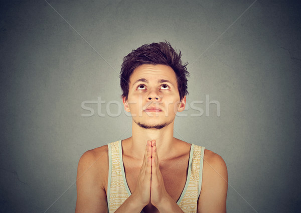 Man praying hands clasped hoping for best asking for forgiveness Stock photo © ichiosea