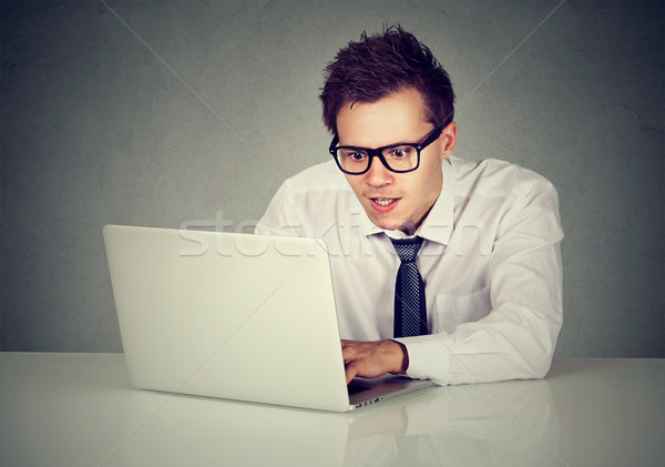 Man using his laptop computer sitting at table  Stock photo © ichiosea