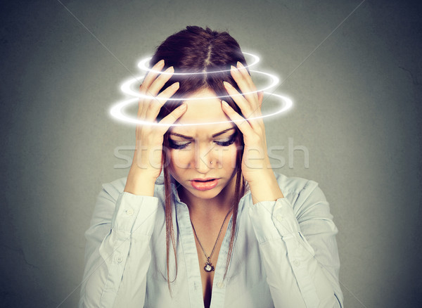 Woman with vertigo. Young female patient suffering from dizziness Stock photo © ichiosea