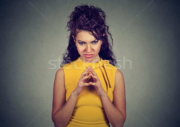 Stock photo: sly, scheming young woman plotting something