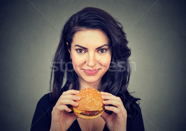 Woman eating burger smiling. Beautiful female model  Stock photo © ichiosea