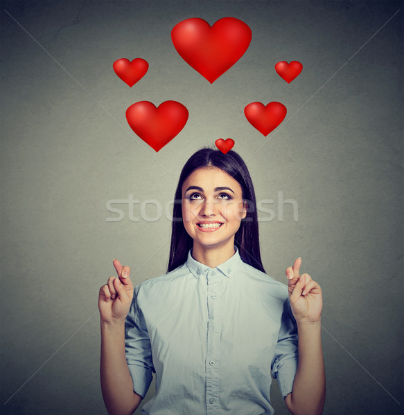 Young woman in love crossing her fingers  Stock photo © ichiosea