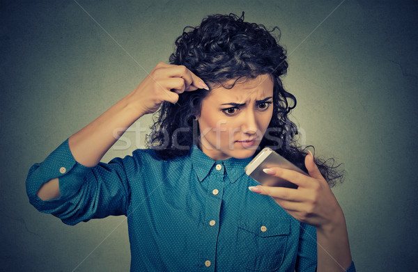 Csalódott zaklatott fiatal nő meglepődött haj közelkép Stock fotó © ichiosea