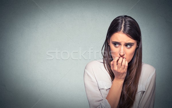 Young hesitant nervous woman biting fingernails craving or anxious Stock photo © ichiosea