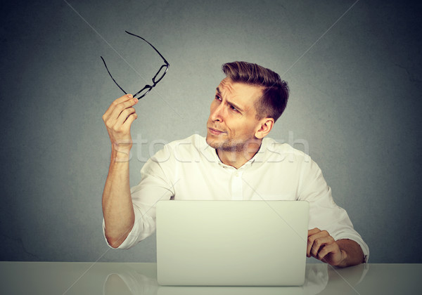 man with glasses having eyesight problems confused with laptop Stock photo © ichiosea
