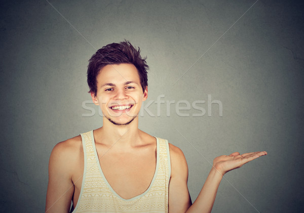 Happy young smiling man pointing to blank space  Stock photo © ichiosea