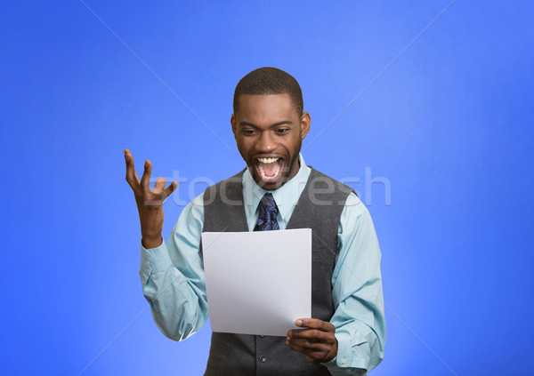 Excited happy man holding document, receiving goood news Stock photo © ichiosea