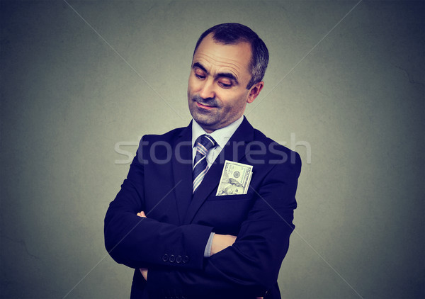 Corrupt businessman with bribery money in suit pocket Stock photo © ichiosea