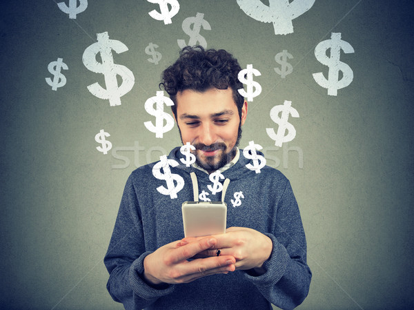 Man earning money via phone Stock photo © ichiosea